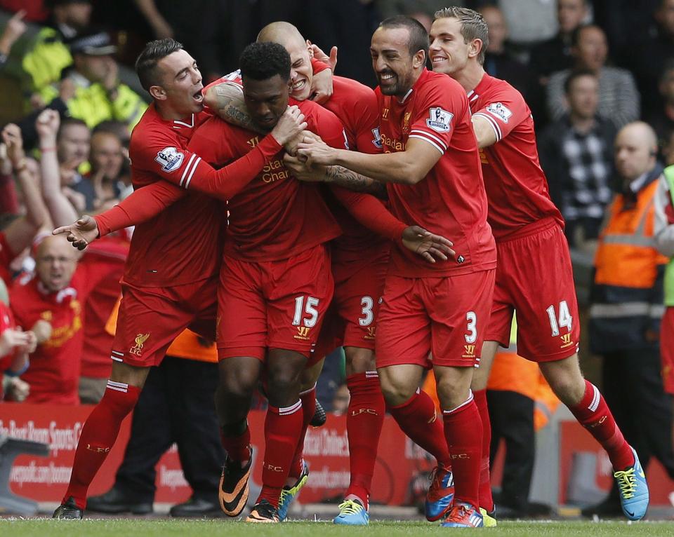 Liverpool's Daniel Sturridge celebrates scoring with teammates during their EPL soccer match against Manchester United at Anfield