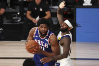 Philadelphia 76ers center Joel Embiid (21) drives to the basket against Indiana Pacers forward JaKarr Sampson during the third quarter of an NBA basketball game Saturday, Aug. 1, 2020, in Lake Buena Vista, Fla. (Kim Klement/Pool Photo via AP)