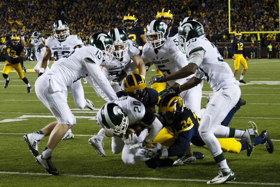Oct. 17, 2015; Ann Arbor; Michigan State Spartans defensive back Jalen Watts-Jackson (20) dives into the end zone for a game winning touchdown as the clock runs out in the fourth quarter against the Michigan Wolverines at Michigan Stadium. Michigan State 27-23. Rick Osentoski-USA TODAY Sports