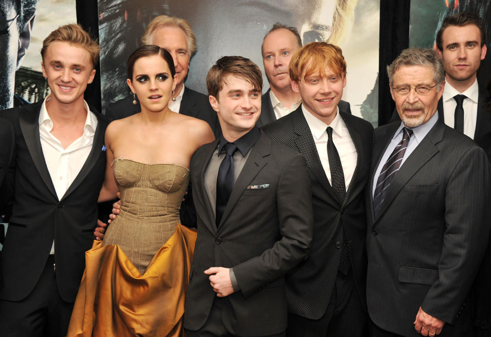 Tom Felton, Emma Watson, Daniel Radcliffe, Rupert Grint, and others at a red carpet event, dressed in formal attire