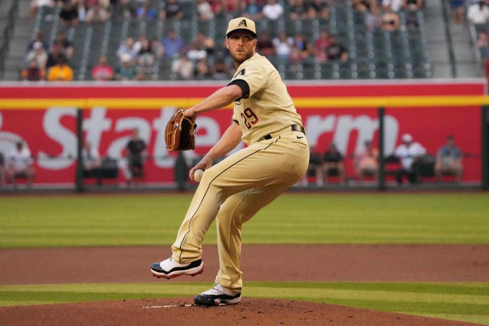 May 6, 2022; Phoenix, Arizona, USA; Arizona Diamondbacks starting pitcher Merrill Kelly (29) pitches against the Colorado Rockies during the first inning at Chase Field. Mandatory Credit: Joe Camporeale-USA TODAY Sports