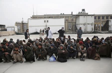 People sit in lines at a newly-opened treatment centre at Camp Phoenix, after a police round up of suspected drug addicts in Kabul, Afghanistan December 27, 2015. REUTERS/Ahmad Masood