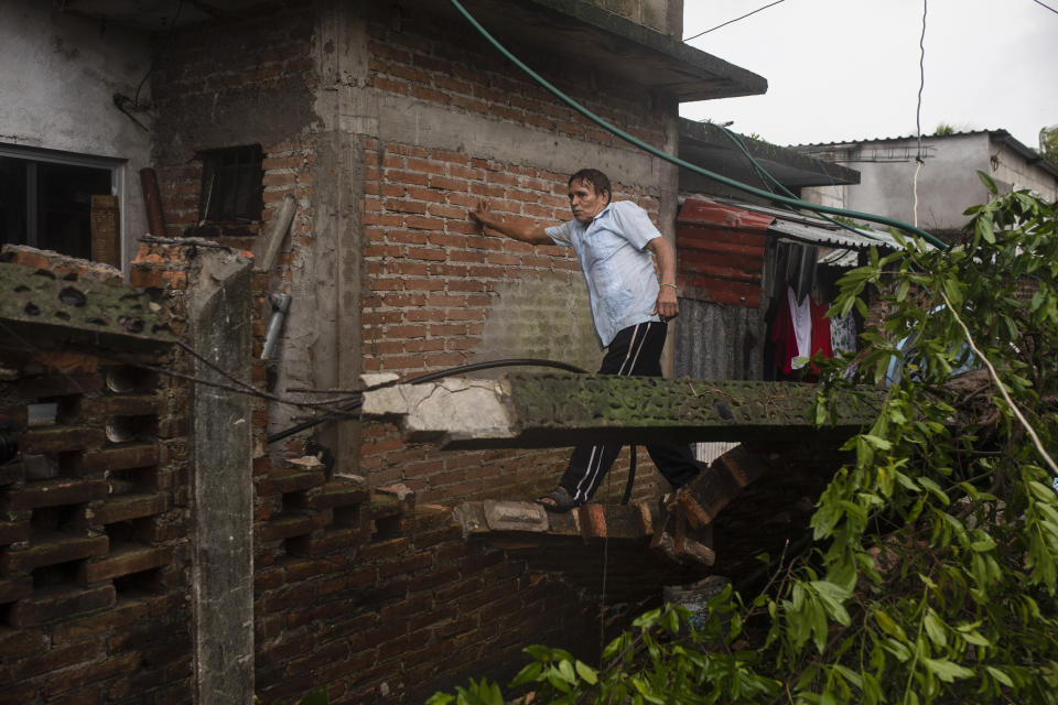 A man inspects the damage after a part of his home was toppled by the winds drought on by Hurricane Grace, in Tecolutla, Veracruz State, Mexico, Saturday, Aug. 21, 2021. Grace hit Mexico’s Gulf shore as a major Category 3 storm before weakening on Saturday, drenching coastal and inland areas in its second landfall in the country in two days. (AP Photo/Felix Marquez)