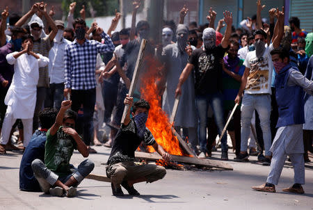 Protesters hold sticks as they shout slogans during a protest in Srinagar against the recent killings in Kashmir, July 23, 2016. REUTERS/Danish Ismail