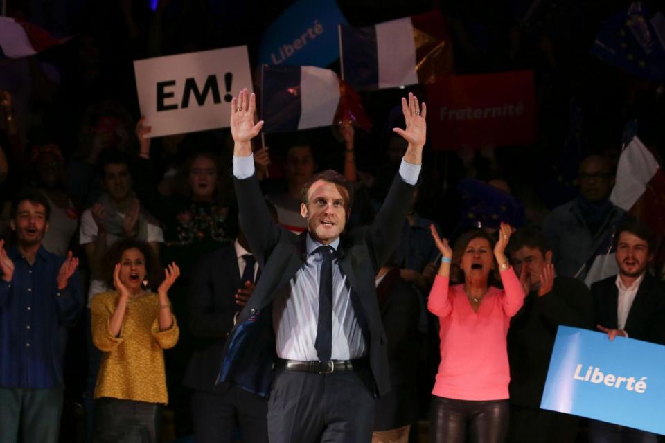 On the campaign trail: French presidential election candidate Emmanuel Macron waves on stage at a London event (DANIEL LEAL-OLIVAS/AFP/Getty Images)