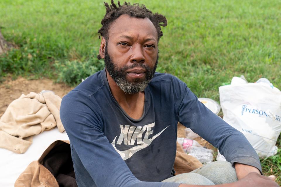 Eddie Perkins poses among a few of his possessions Friday southwest of the Topeka Rescue Mission homeless shelter operated by TRM Ministries.