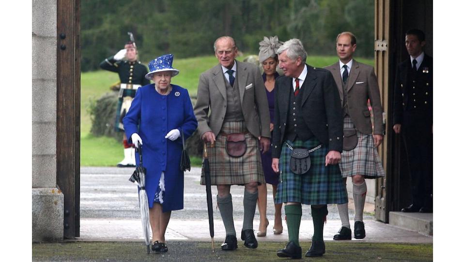 Queen Elizabeth II and Prince Edward,  Earl of Wessex walk with Prince Philip, Duke of Edinburgh (2nd left) on August 07, 2012 in Aberdeenshire, United Kingdom.