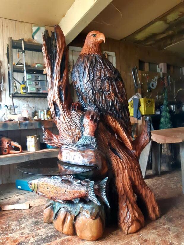 A carved wooden eagle side table was one of many artworks destroyed by the fire in Ken Sheen's studio last Friday. 