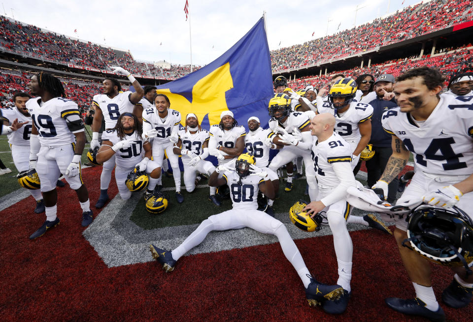 Nov. 26, 2022; Columbus, Ohio; Michigan Wolverines players plant the flag on the Ohio State Buckeyes 50-yard line following the win at Ohio Stadium. Joseph Maiorana-USA TODAY Sports