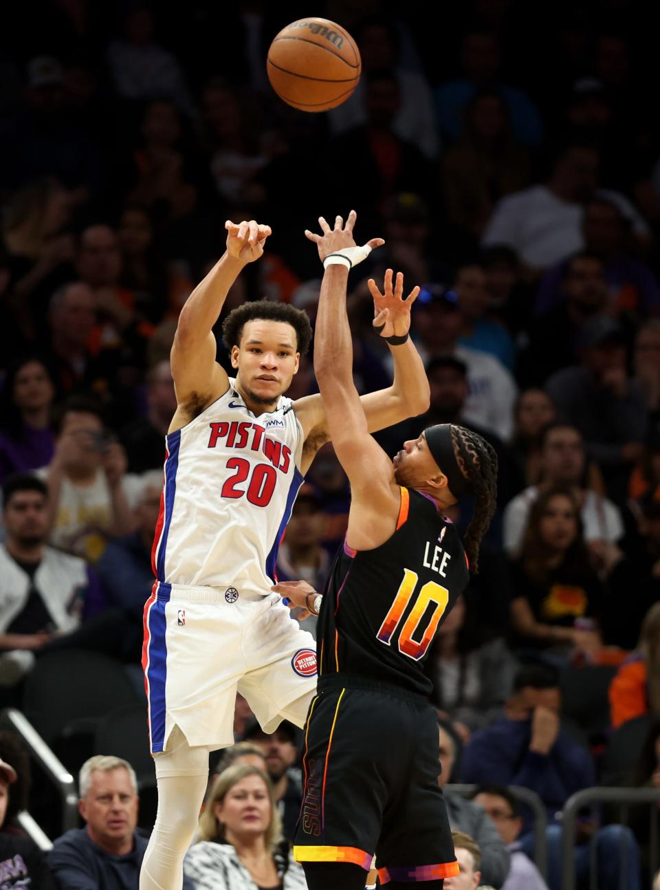 Nov 25, 2022; Phoenix, Arizona, USA; Detroit Pistons forward Kevin Knox II (20) passes the ball against Phoenix Suns guard Damion Lee (10) in the first half at Footprint Center.