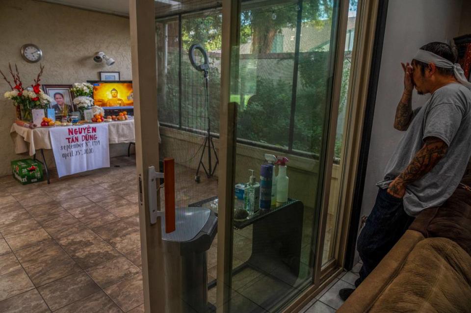 Bao Nguyen, 45, says “I think the whole community would be here,” as he waits for visitors to pay respects in his home, on Monday, May 4, 2020, where he and his wife Trang Nguyen created a prayer room to honor his father Dung Tan Nguyen who died on April 25. If it wasn’t for the coronavirus, at least 15 Buddhist monks would’ve chanted prayers for him, but instead a video of chanting is played. Also in the room is an array of hand sanitizer, gloves, masks and cleaning fluids for those to use during their visit. “It’s kind of a sad way to do it. I’m not used to it. It’s kind of the new way, new normal of our world right now,” said Nguyen who was explaining that only four people will be allowed at the funeral service and that only two people at a time will be allowed to lay flowers on the casket after it is lowered into the grave at the cemetery.