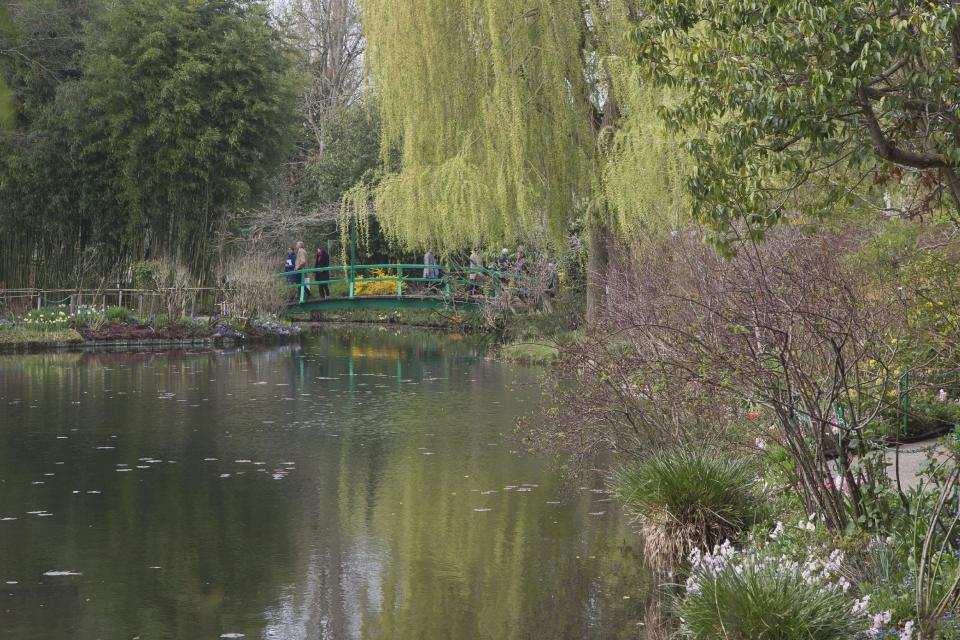 People cross the Japanese bridge at the waterlily pond at the Claude Monet museum in Giverny, 70 kms (45 mls)north west of Paris, Friday, March 28, 2014. A new exhibit at Normandy’s Impressionism Museum tells for the first time the little-known story of American Impressionism from where it all began _ at the picturesque water lily-filled Giverny gardens of Claude Monet that Americans colonized for three decades. (AP Photo/Michel Euler)