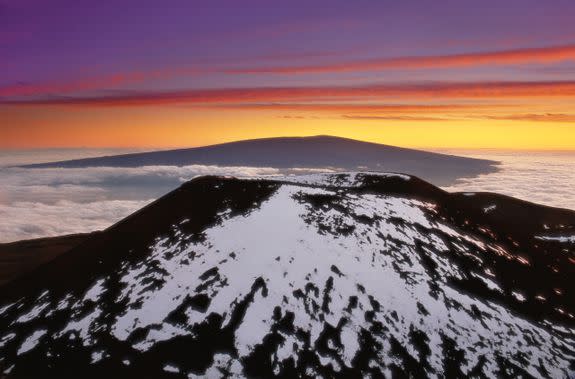 The view of Mauna Loa from the top of snow-peaked Mauna Kea, another Big Island volcano.