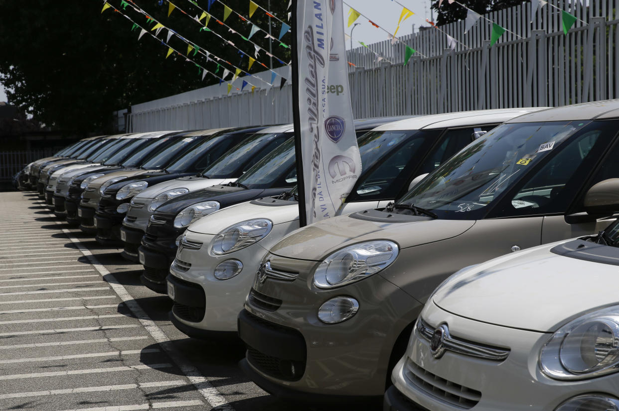 Cars are parked at a Fiat car dealer in Milan, Italy, Wednesday, July 25, 2018. Sergio Marchionne, a charismatic and demanding CEO who engineered two long-shot corporate turnarounds to save both Fiat and Chrysler from near-certain failure, died Wednesday. He was 66. The holding company of Italian automaker Fiat's founders, the Agnelli family, announced Marchionne had died after complications from surgery in Zurich. At Fiat Chrysler Automobiles headquarters in the Italian town of Turin, flags flew at half-mast, while in Rome the parliamentary committee for labor and finance observed a minute of silence. (AP Photo/Luca Bruno)