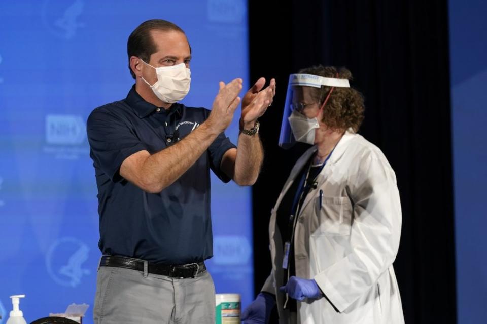 U.S. Secretary of Health and Human Services Alex Azar applauds after receiving his first dose of the COVID-19 vaccine at the National Institutes of Health on December 22, 2020 in Bethesda, Maryland. (Photo by Patrick Semansky-Pool/Getty Images)