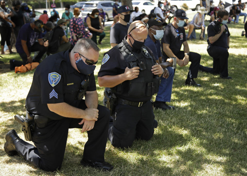 Fairfield police officers kneel during "Taking a knee for Justice and Prayer" service on Wednesday, June 3, 2020, in Fairfield, Calif. (AP Photo/Ben Margot)