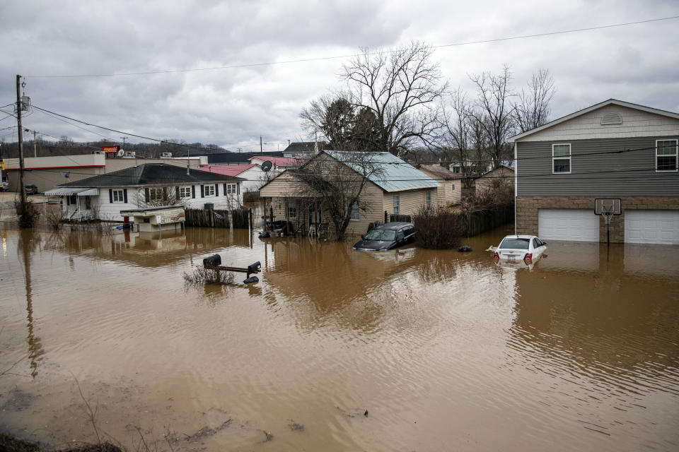 Flood water enters homes at the intersection of McGhee and Mason Street on Friday, Feb. 17, 2023, in Milton, W.Va. The flooding came amid a string of thunderstorms that inundated the South and dumped nearly 3 inches (8 centimeters) of rain in parts of West Virginia. (Sholten Singer/The Herald-Dispatch via AP)
