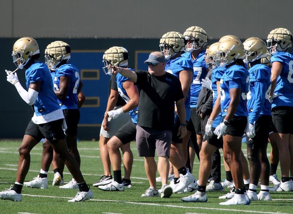 UCLA coach Chip Kelly directs his team during a preseason practice session at Spaulding Field.