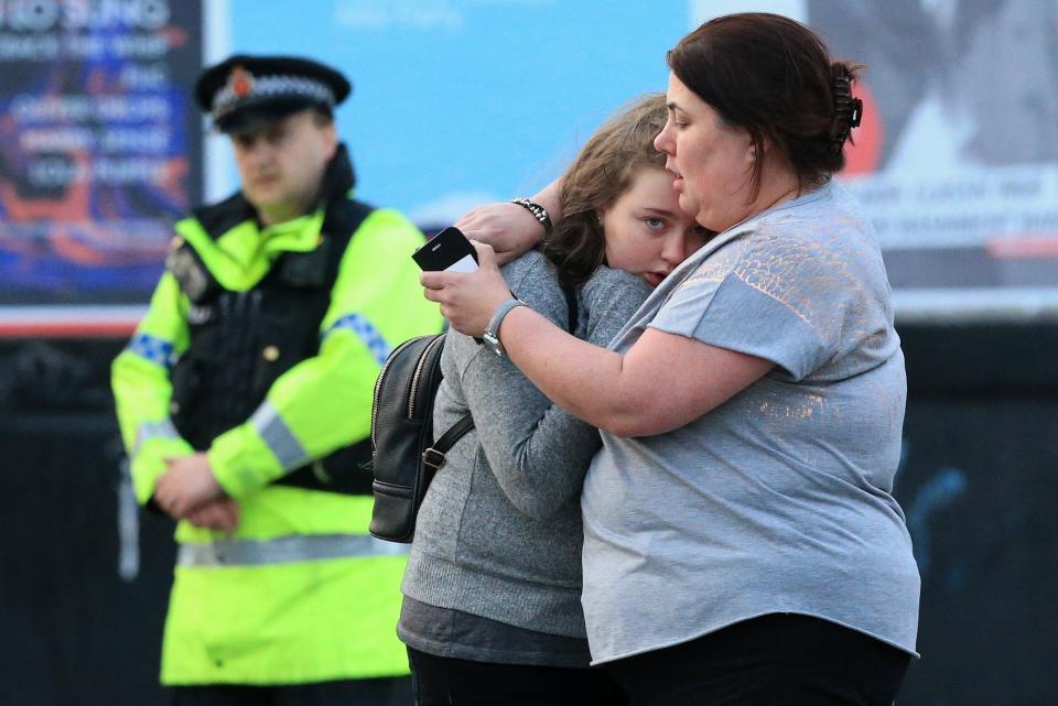 Vikki Baker and her thirteen year old daughter Charlotte hug outside the Manchester Arena.&nbsp;