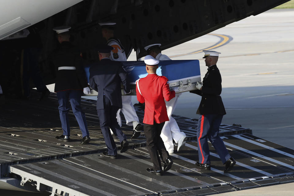 Honor guards carry the remains of U.S. servicemen killed in the Korean War and collected in North Korea, during a ceremony at the Osan Air Base in Pyeongtaek, South Korea, Wednesday, Aug. 1, 2018. North Korea handed over 55 boxes of the remains last week as part of agreements reached during a historic June summit between its leader Kim Jong Un and U.S. President Donald Trump. (Chung Sung-Jun/Pool Photo via AP)