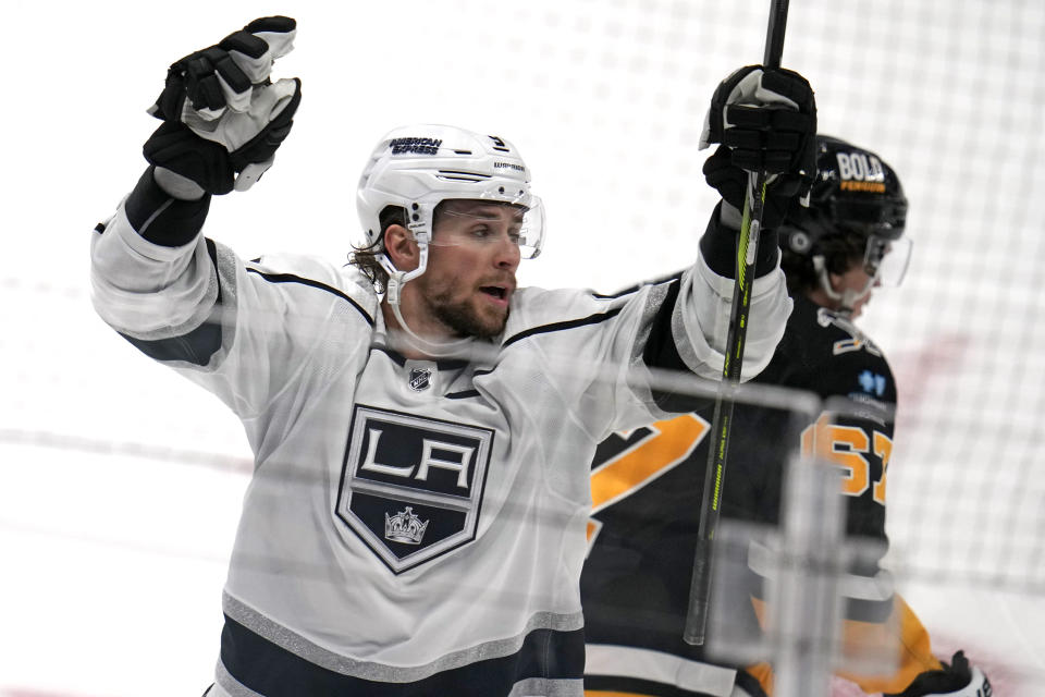 Los Angeles Kings' Adrian Kempe, left, celebrates after his goal in the third period during an NHL hockey game against the Pittsburgh Penguins in Pittsburgh, Sunday, Feb. 18, 2024. (AP Photo/Gene J. Puskar)