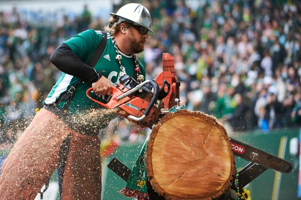 Timbers Joey uses a chainsaw to cut into a log after a Timbers goal during a 2-1 win against Los Angeles FC at Providence Park on Sunday.