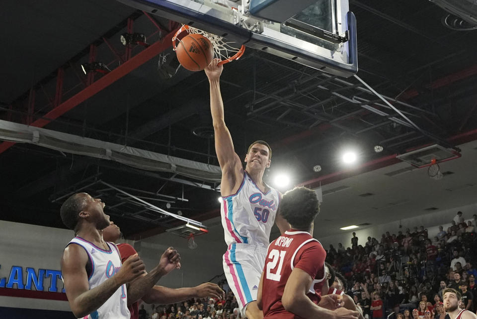 Florida Atlantic center Vladislav Goldin (50) dunks the ball over Temple center Emmanuel Okpomo (21) during the first half of an NCAA college basketball game, Thursday, Feb. 15, 2024, in Boca Raton, Fla. (AP Photo/Marta Lavandier)