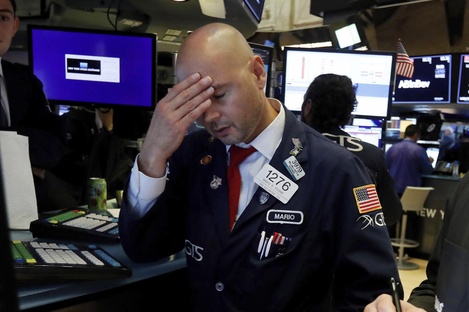 Specialist Mario Picone works on the floor of the New York Stock Exchange, Wednesday, Aug. 14, 2019. The Dow Jones Industrial Average sank 800 points after the bond market flashed a warning sign about a possible recession for the first time since 2007. (AP Photo/Richard Drew)