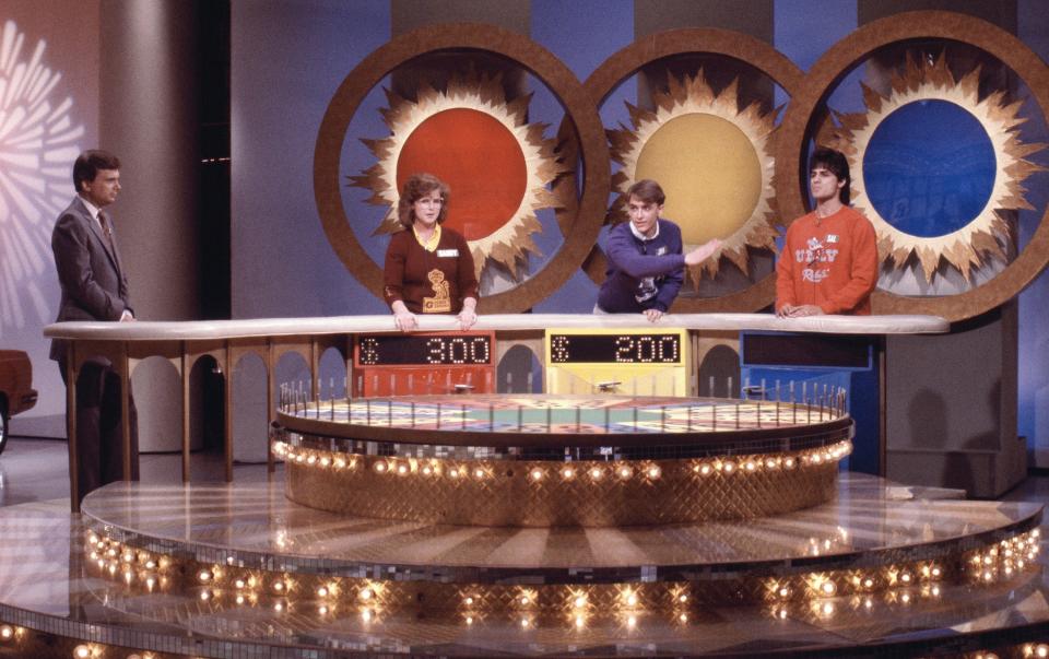 Pat Sajak with "Wheel of Fortune" contestants.