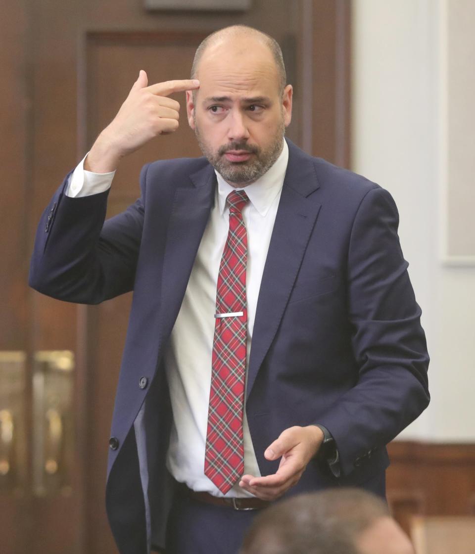 Elliot Kolkovich, then assistant Summit County prosecutor, demonstrates to jurors how authorities believe Eric Pursley shot and killed landlord Daniel Stein during closing arguments on July 20, 2023.