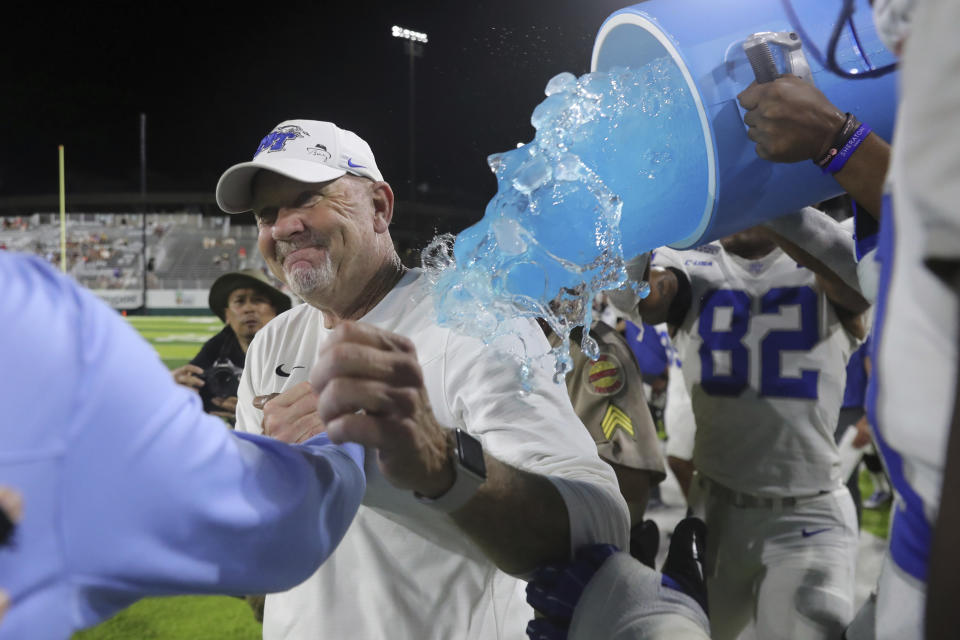 Middle Tennessee head coach Rick Stockstill is dowsed after his team defeated San Diego State 25-23 at the Hawaii Bowl NCAA college football game, Saturday, Dec. 24, 2022, in Honolulu. (AP Photo/Marco Garcia)