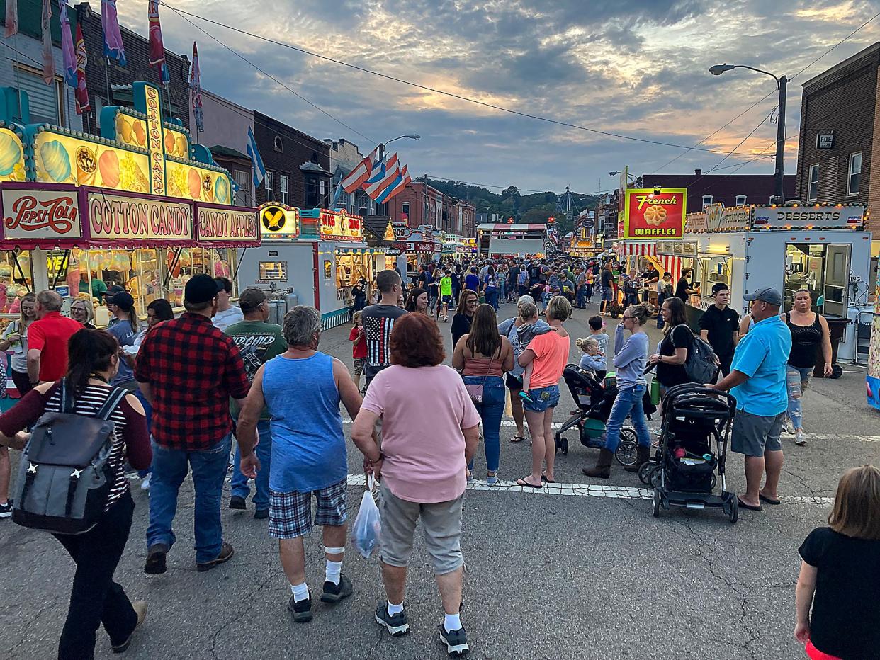 People walk down Main Street as the sun sets on the Loudonville Street Fair on Wednesday, Oct. 6, 2021. TOM E. PUSKAR/TIMES-GAZETTE.COM