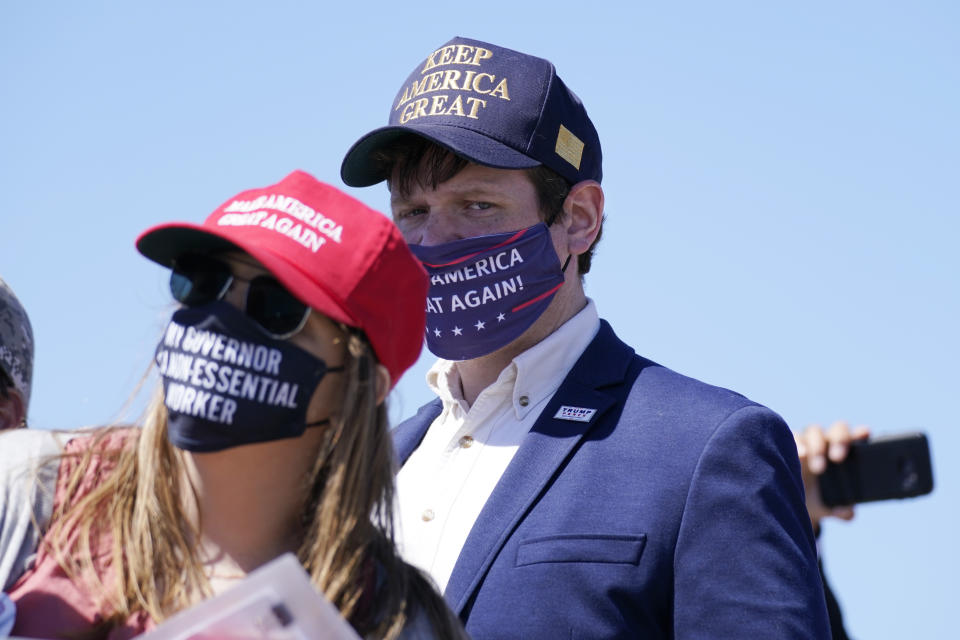 Supporters watch as President Donald Trump speaks to a crowd at the Minneapolis-Saint Paul International Airport, Monday, Aug. 17, 2020, in Minneapolis. (AP Photo/Evan Vucci)