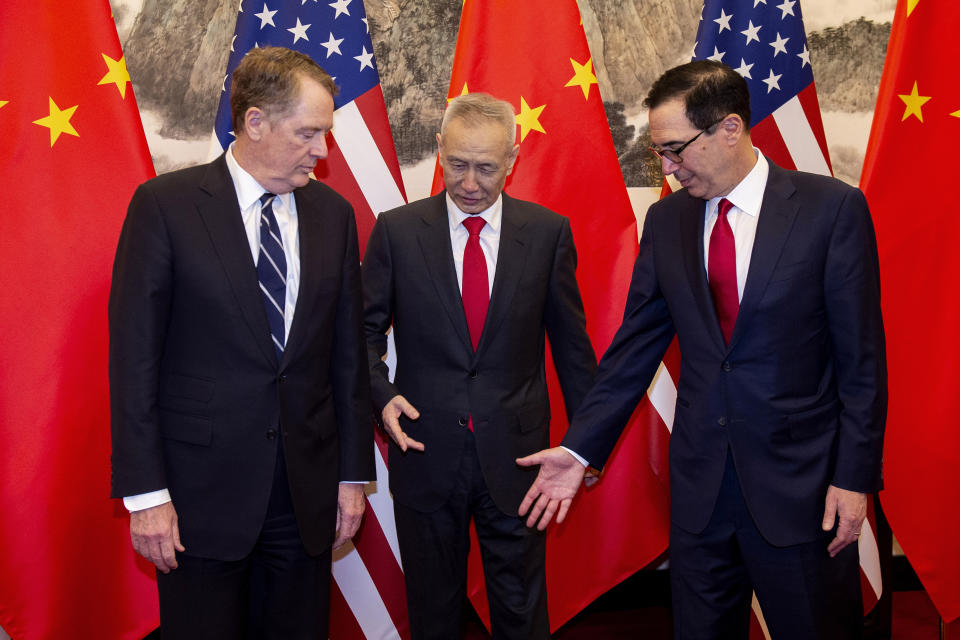 China's Vice Premier Liu He, center, gestures with U.S. Treasury Secretary Steven Mnuchin, right, as U.S. Trade Representative Robert Lighthizer looks on as they pose for a photo at Diaoyutai State Guesthouse in Beijing Friday, March 29, 2019. (Nicolas Asfouri/Pool Photo via AP)