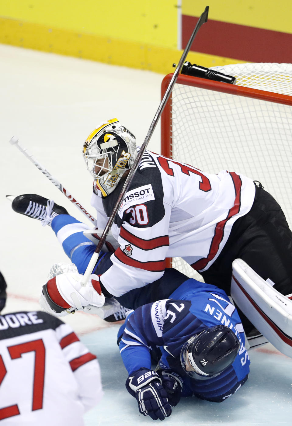 Finland's Jere Sallinen, down, collides with Canada's goaltender Matt Murray, up, during the Ice Hockey World Championships group A match between Finland and Canada at the Steel Arena in Kosice, Slovakia, Friday, May 10, 2019. (AP Photo/Petr David Josek)