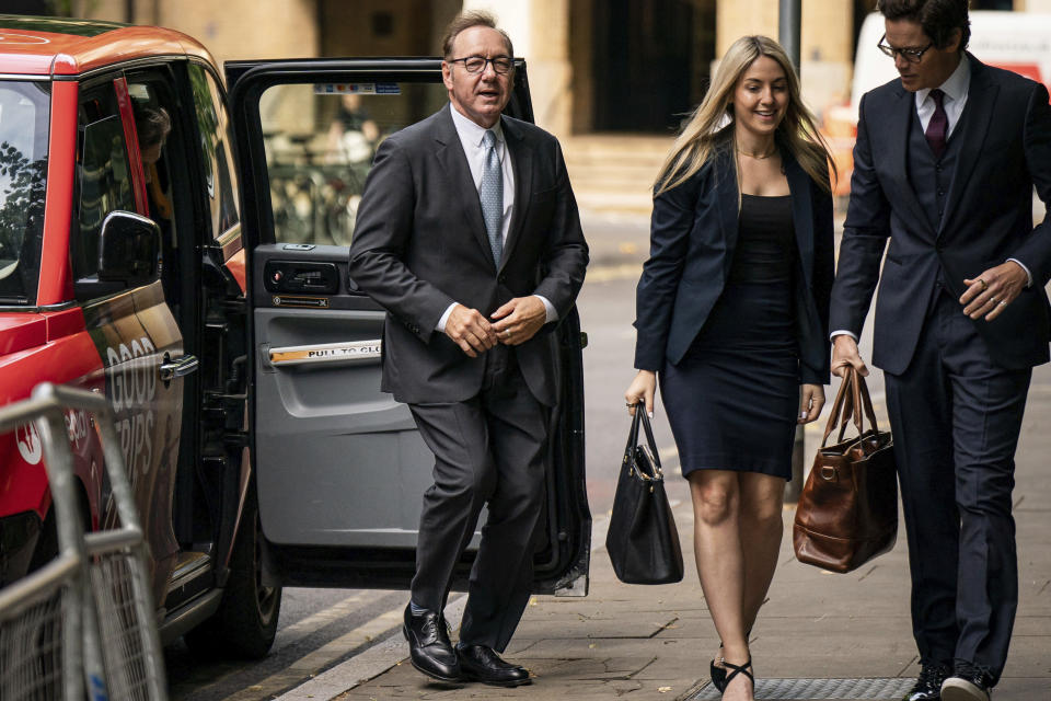 Actor Kevin Spacey, left, arrives at Southwark Crown Court, London, where he is charged with three counts of indecent assault, seven counts of sexual assault, one count of causing a person to engage in sexual activity without consent and one count of causing a person to engage in penetrative sexual activity without consent between 2001 and 2005, on Thursday July 13, 2023. (Aaron Chown/PA via AP)