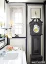 <p>Without the moisture and humidity from a shower to worry about, you can show off an antique, like this grandfather-style clock. Ideal for filling a narrow span of wall, the timepiece complements the nattiness of the tailored bands of black paint.</p>