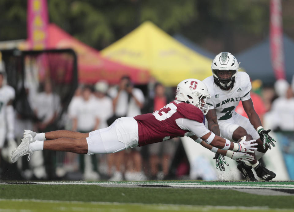 Stanford safety Alaka'i Gilman (33) almost comes up with an interception on a pass intended for Hawaii running back Tylan Hines (2) during the first half of an NCAA college football game Friday, Sept. 1, 2023, in Honolulu. (Jamm Aquino/Honolulu Star-Advertiser via AP)