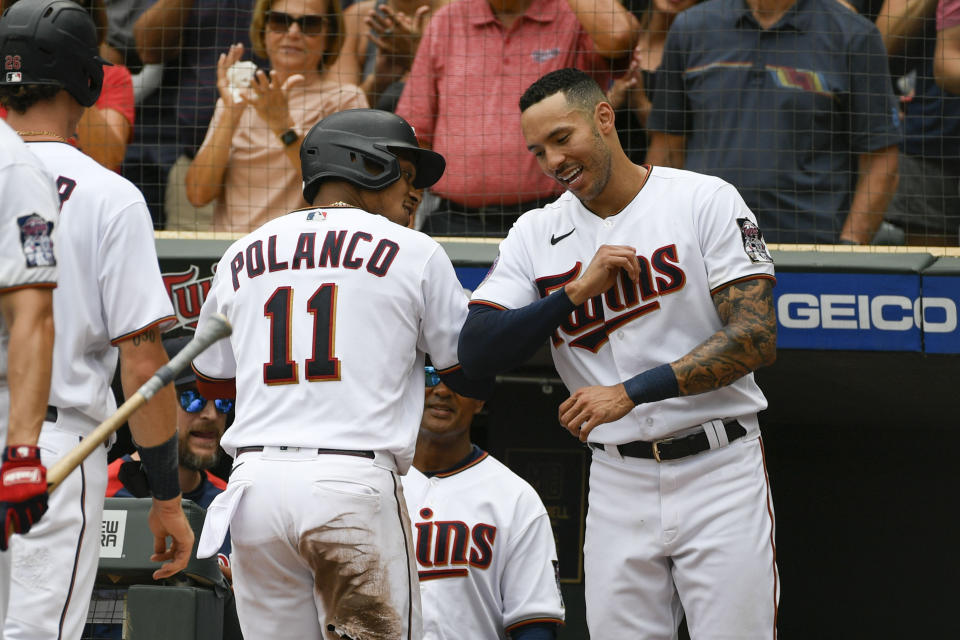 Minnesota Twins' Jorge Polanco (11) celebrates with Carlos Correa after hitting a three-run home run against Chicago White Sox pitcher Lance Lynn during the third inning of a baseball game, Saturday, July 16, 2022, in Minneapolis. Max Kepler and Bryon Buxton scored. (AP Photo/Craig Lassig)