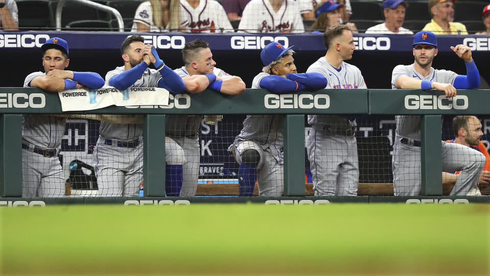 The New York Mets watch from the dugout during the ninth inning of the team's baseball game against the Atlanta Braves on Monday, Aug. 15, 2022, in Atlanta. (Curtis Compton/Atlanta Journal-Constitution via AP)