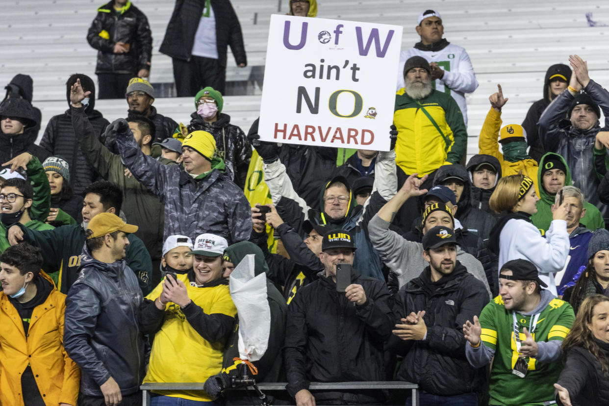 A fan holds up a sign after an NCAA college football game between Oregon and Washington referring to comments by Washington head coach Jimmy Lake, Saturday, Nov. 6, 2021, in Seattle. Oregon won 26-16. (AP Photo/Stephen Brashear)