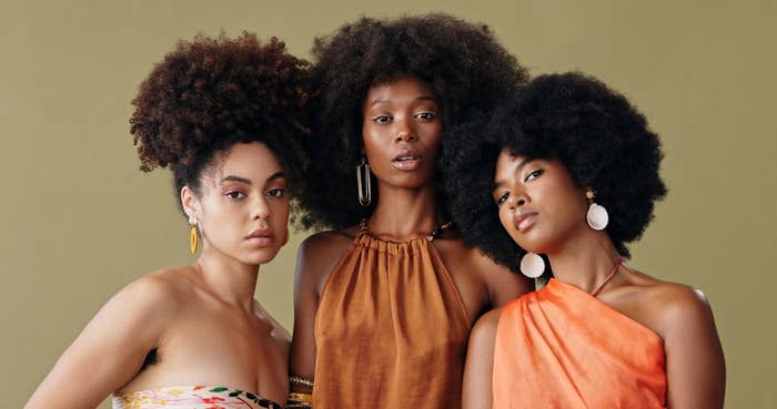 three women with curly hair