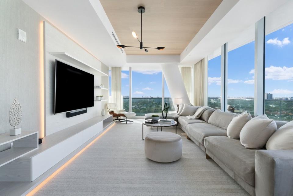 a living room with a tv and a large window