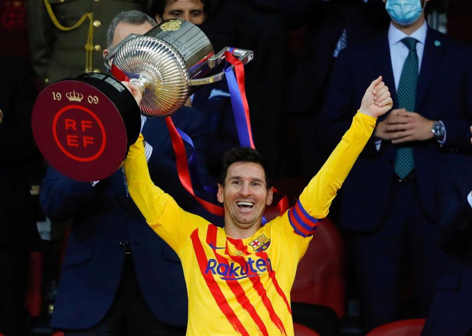 Lionel Messi celebrates with the trophy (Reuters)