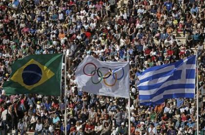 The Brazilian, Olympic and Greek flags fly over the Panathenaic Stadium during the handover ceremony of the Olympic Flame to the delegation of the 2016 Rio Olympics, in Athens, Greece, April 27, 2016. REUTERS/Alkis Konstantinidis