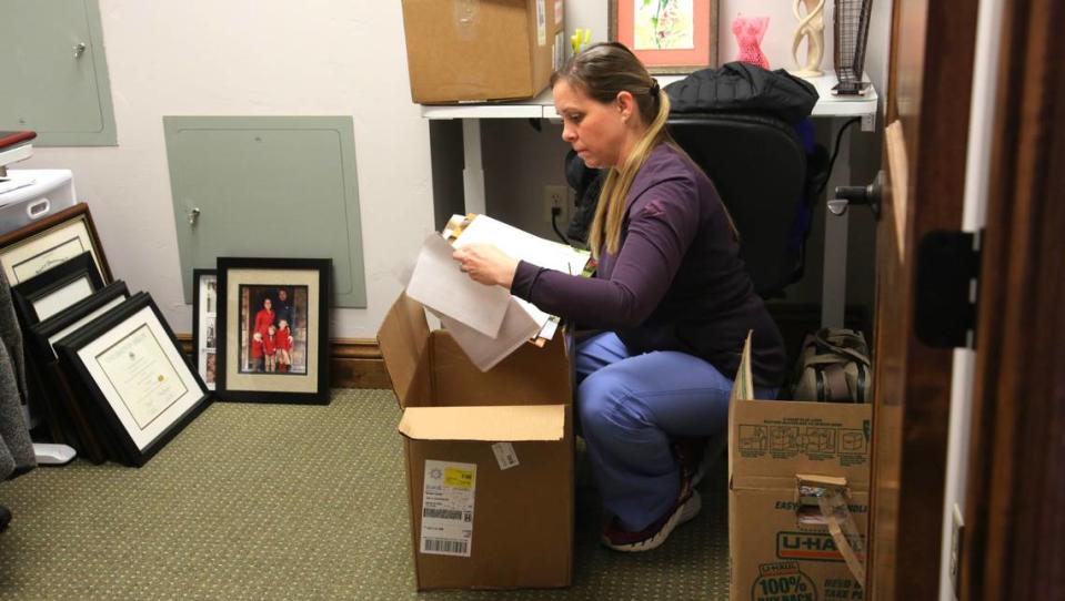 Cortney Schnupp, a certified nurse-midwife who previously worked at Saltzer, unpacks boxes at Grace Women’s Health, a new clinic in Nampa.