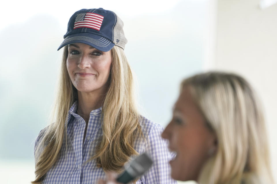 Sen. Kelly Loeffler, R-Ga., listens to Republican congressional candidate Marjorie Taylor Greene speak during a news conference on Thursday, Oct. 15, 2020, in Dallas, Ga. (AP Photo/Brynn Anderson)