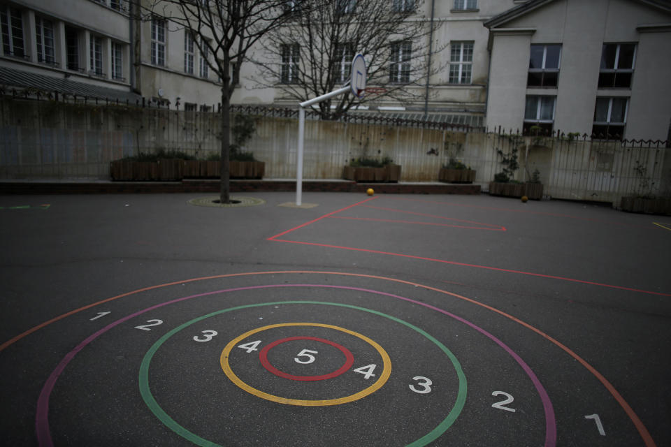 An empty courtyard is seen at a closed school in Paris, Monday, March 16, 2020. France plans to close all creches, schools and universities from Monday until further notice to limit the spread of the novel coronavirus, President Emmanuel Macron says. For most people, the new coronavirus causes only mild or moderate symptoms. For some it can cause more severe illness, especially in older adults and people with existing health problems. (AP Photo/Thibault Camus)