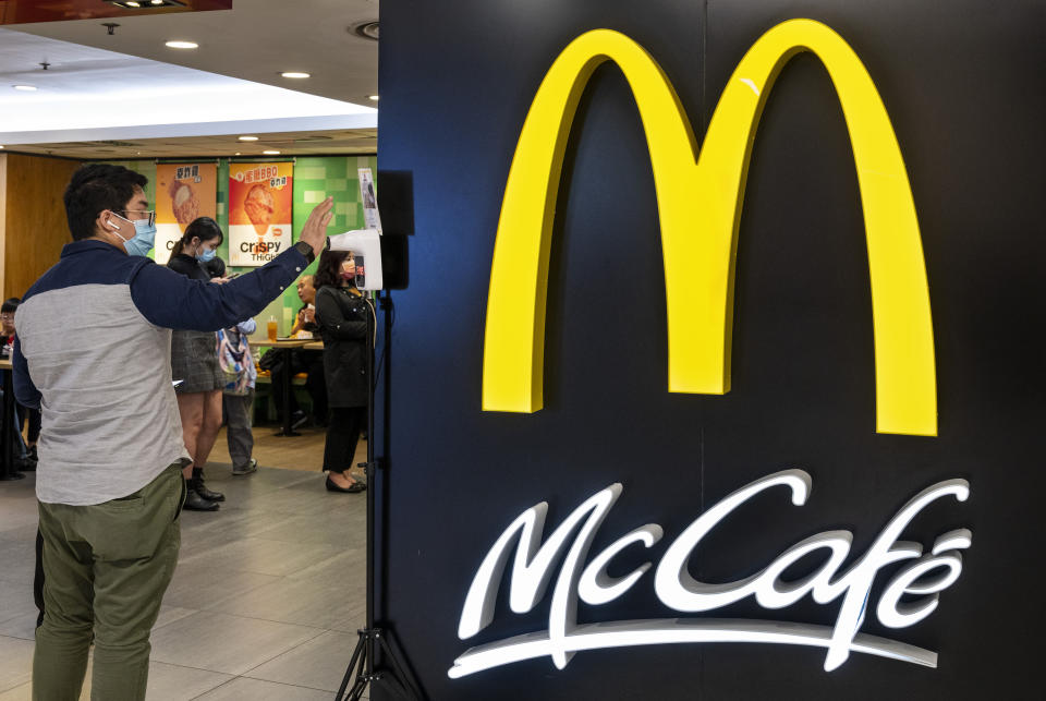 HONG KONG, CHINA - 2021/04/18: A customer goes through a temperature check before walking inside the American multinational fast-food hamburger restaurant chain McDonald's and McCafe in Hong Kong. (Photo by Budrul Chukrut/SOPA Images/LightRocket via Getty Images)