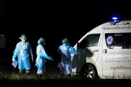 Rescue workers wearing protection suits are seen as they wait for rescued schoolboys at military airport in Chiang Rai, Thailand, July 9, 2018. REUTERS/Athit Perawongmetha